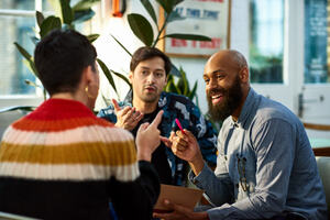 Multi ethnic group sharing ideas in an office 